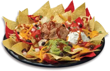 a plate of nachos with meat and vegetables