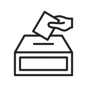 a hand putting a voting paper into a ballot box