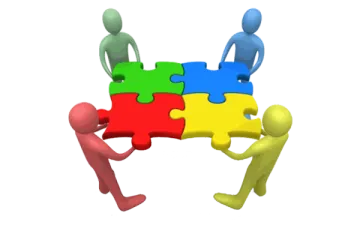 a group of people standing around a puzzle