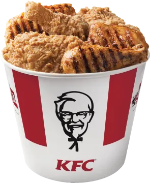 a cup filled with chicken sitting on top of a table