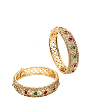 a pair of gold rings with red and green stones