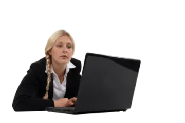 a woman sitting at her desk using a laptop