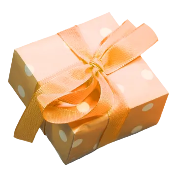 a gift box with a gold bow and polka dots