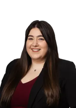 a woman in a black jacket and red top