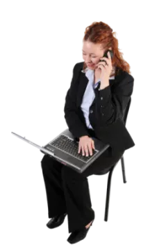 a woman sitting on a chair while talking on her cell