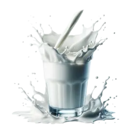 a glass of milk with a spoon in it