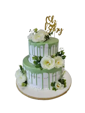 a green and white cake with flowers on top