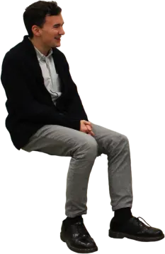a man sitting on top of a stool