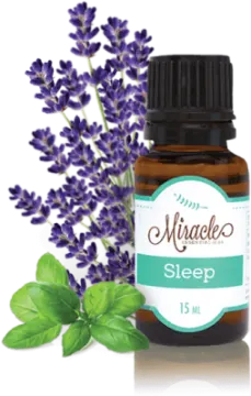 a bottle of lavender essential oil next to some flowers