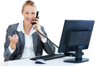 a woman sitting at her desk talking on the phone