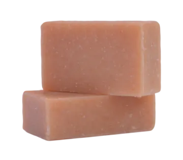 a block of orange soap on a white background