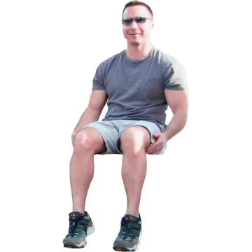 a man sitting on a stool with his legs crossed