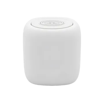 a white speaker sitting on top of a table