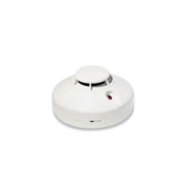 a white smoke detector with a red light