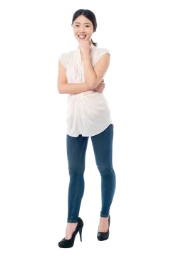 a woman standing with her arms crossed and looking at the camera
