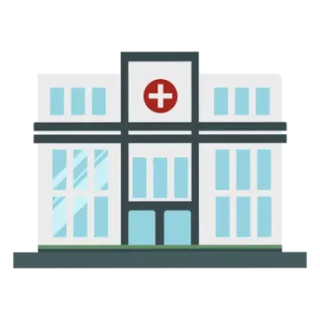 a hospital building with a red cross on the front