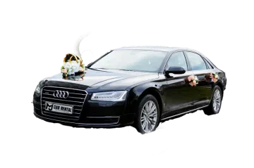 a black audi car with flowers on the hood
