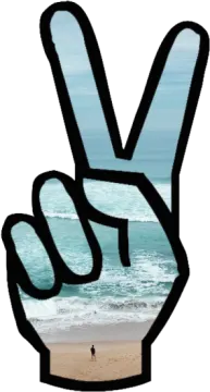 a peace sign on a beach with the ocean in the background