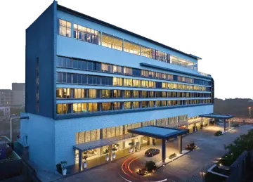 a large white building with many windows at night