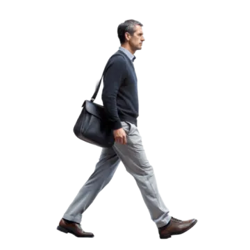a man in a suit and tie walking with a briefcase