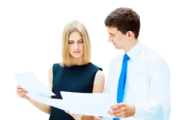 a man and woman are looking at papers
