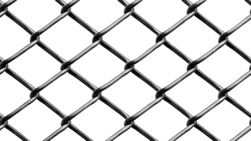 a black and white photo of a chain fence