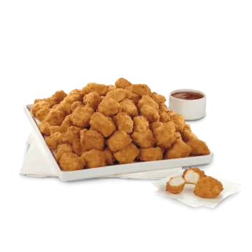a plate of fried food next to a cup of sauce