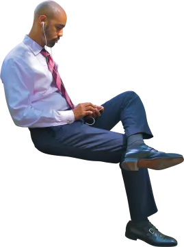 a man in a shirt and tie sitting on a chair