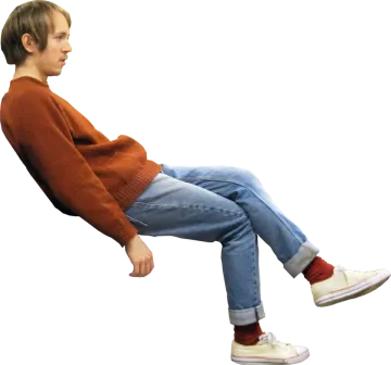 a young boy sitting on a white background