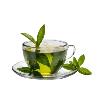 a glass cup filled with green tea leaves