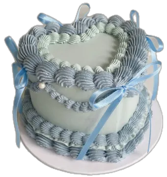 a heart shaped cake with blue ribbons on top