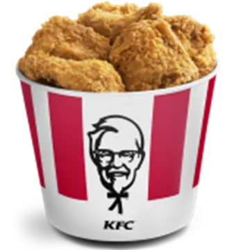 a cup filled with fried chicken sitting on top of a table