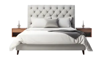 a bed with a white comforter and pillows