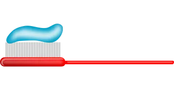 a tooth and toothbrush on a white background