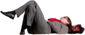 a man in a suit laying on the ground