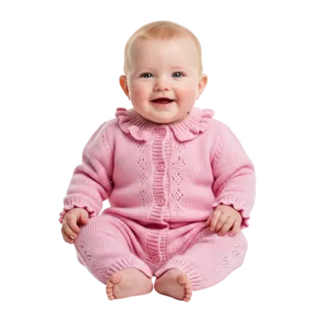 a baby sitting on the floor wearing a pink sweater