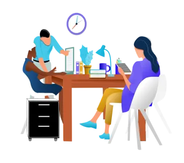 two people sitting at a table working on laptops