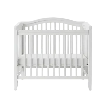 a white cribt with a todd's bed