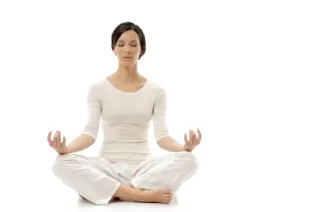 a woman sitting in the middle of a yoga pose