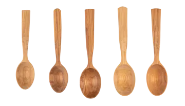 a set of four wooden spoons on a white background