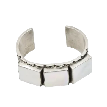 a silver cuff bracelet with a square design