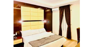 a hotel room with a bed and curtains