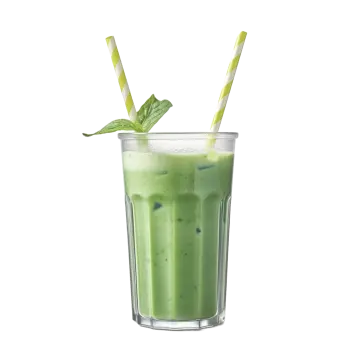 a green smoothie in a glass with two straws