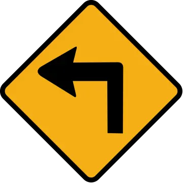 a yellow road sign with an arrow pointing left
