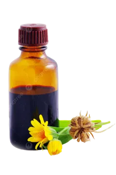 a bottle filled with liquid next to a flower