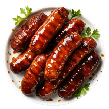 a white plate topped with grilled sausages covered in barbecue sauce