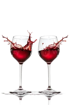 two wine glasses with red wine splashing out of them