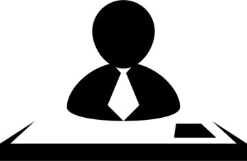 a black and white silhouette of a person sitting at a desk