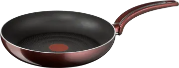 a frying pan with a red handle