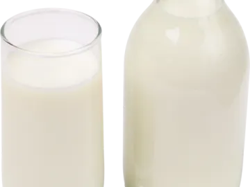 a bottle of milk next to a glass